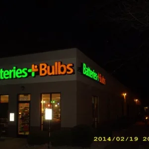 Exterior business logo sign illuminated with channel letters