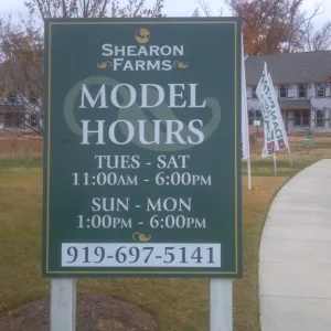 New build neighborhood panel and post office hour sign