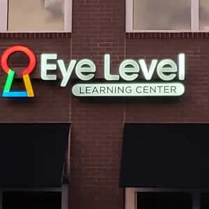 Business storefront logo and name illuminated with channel letters