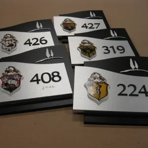 Room number plaque with logo ADA sign