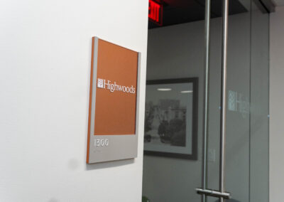 "Corporate signage displaying suite number with company logo, set against a contrasting backdrop for clear visibility."