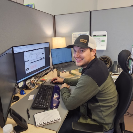 A SignCraft Solutions staff member working at a computer in their office.